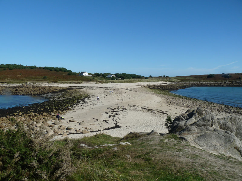 The tombolo sandbar at low tide, that is underwater at high tide, joining Gugh in the distance, to St Agnes 